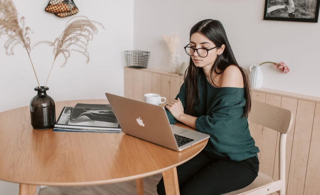 Someone working at a laptop in a bright room