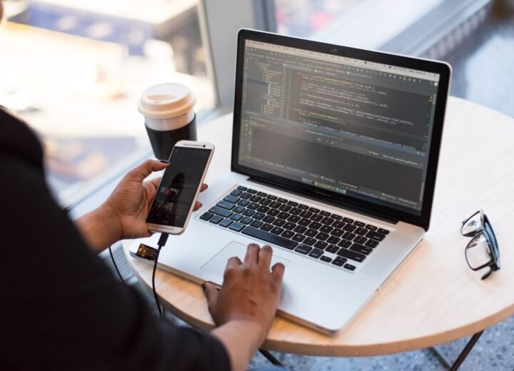 Laptop and coffee on a desk during a work session