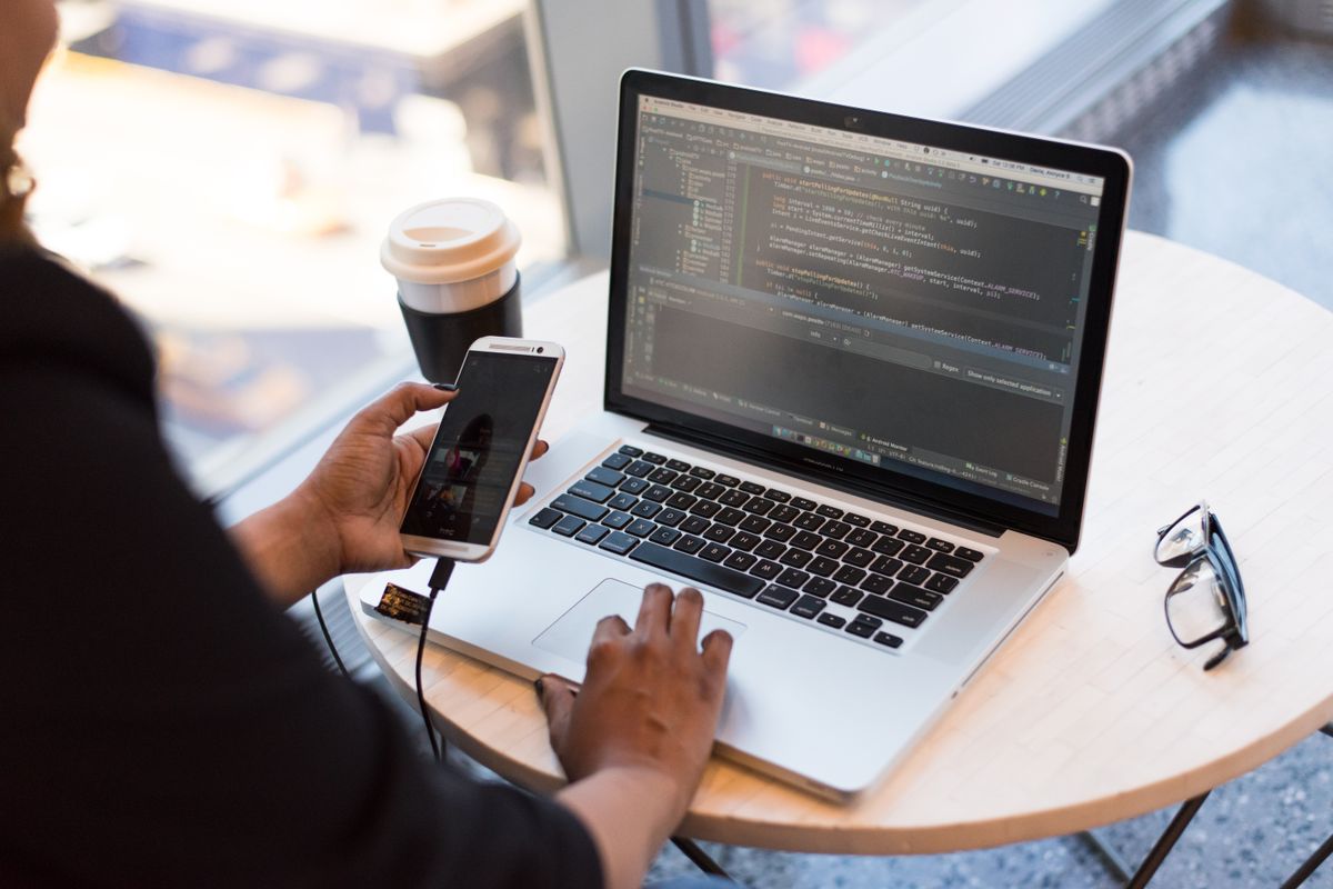 Laptop and coffee on a desk during a work session
