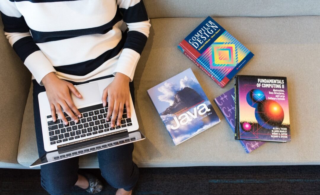 A desk covered in colourful printed design work