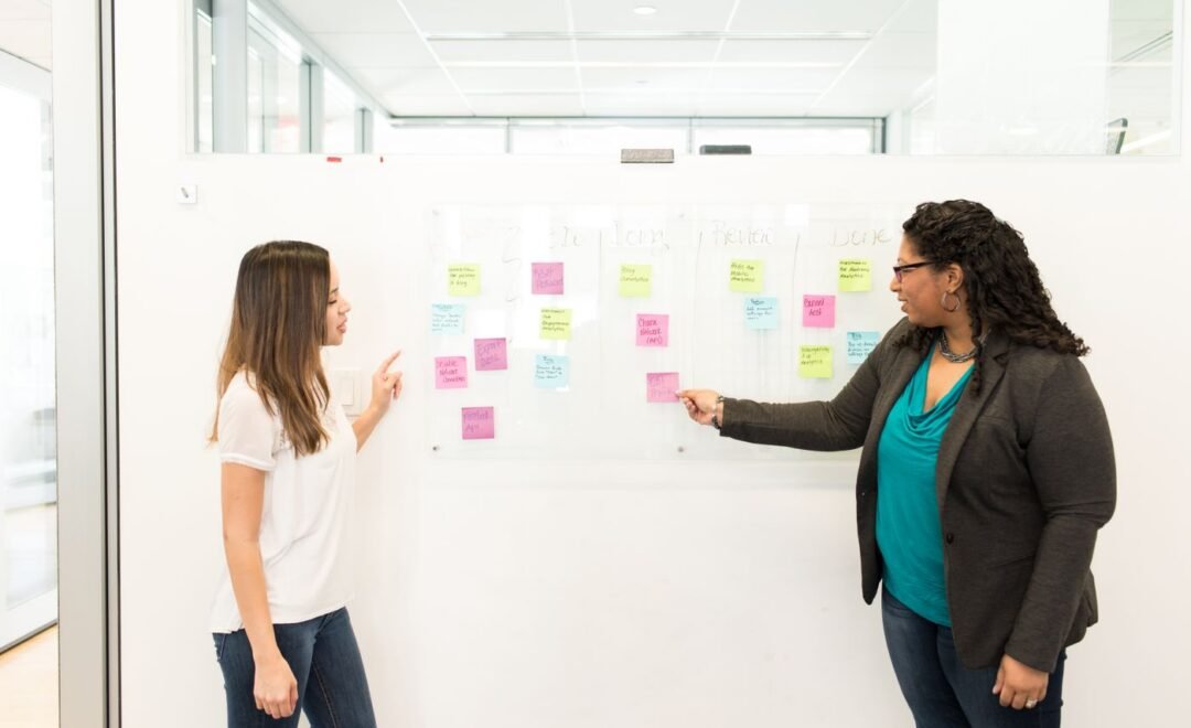 A team planning an app project on a whiteboard