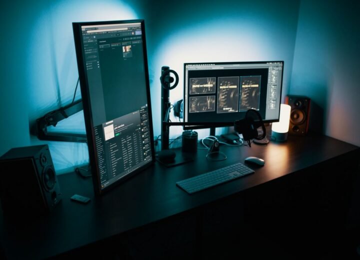 Desk setup with monitors lit in the evening