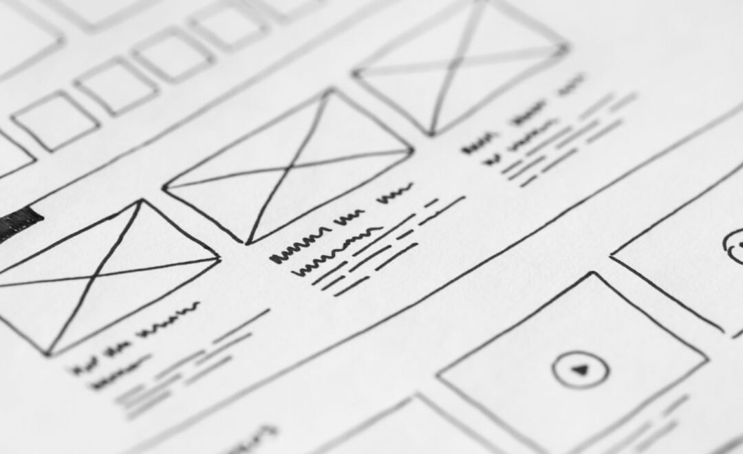 Wireframe sketches for a website layout on paper