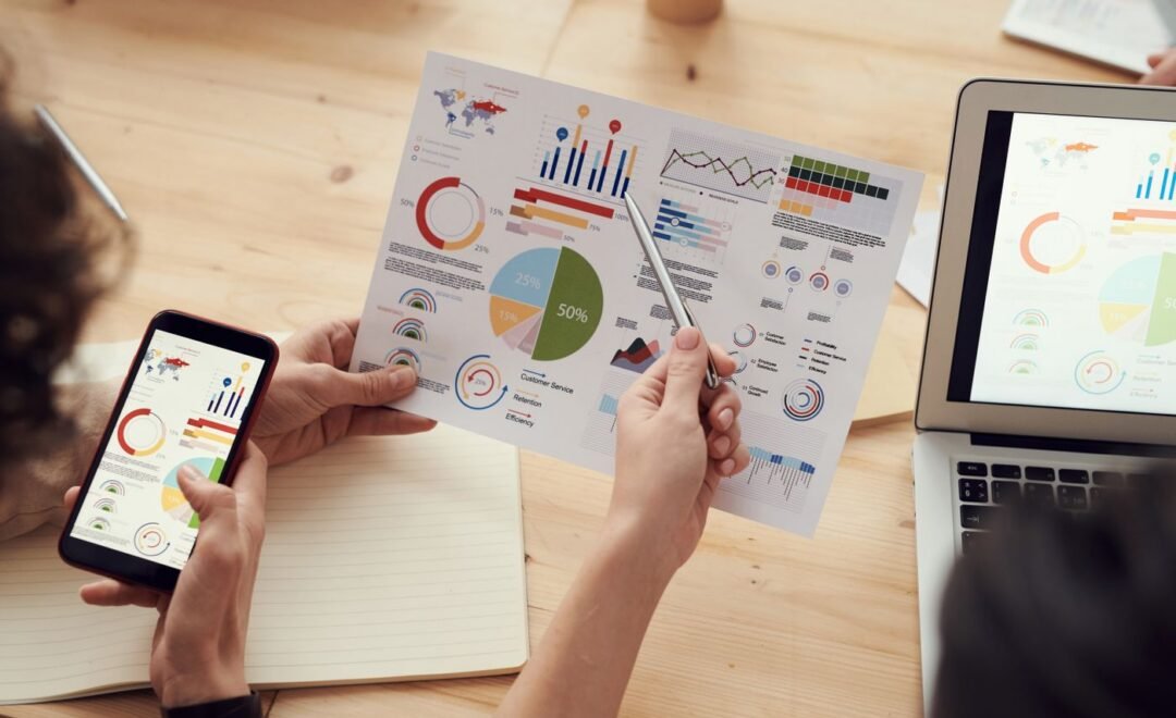 Analytics charts open on a phone and a laptop
