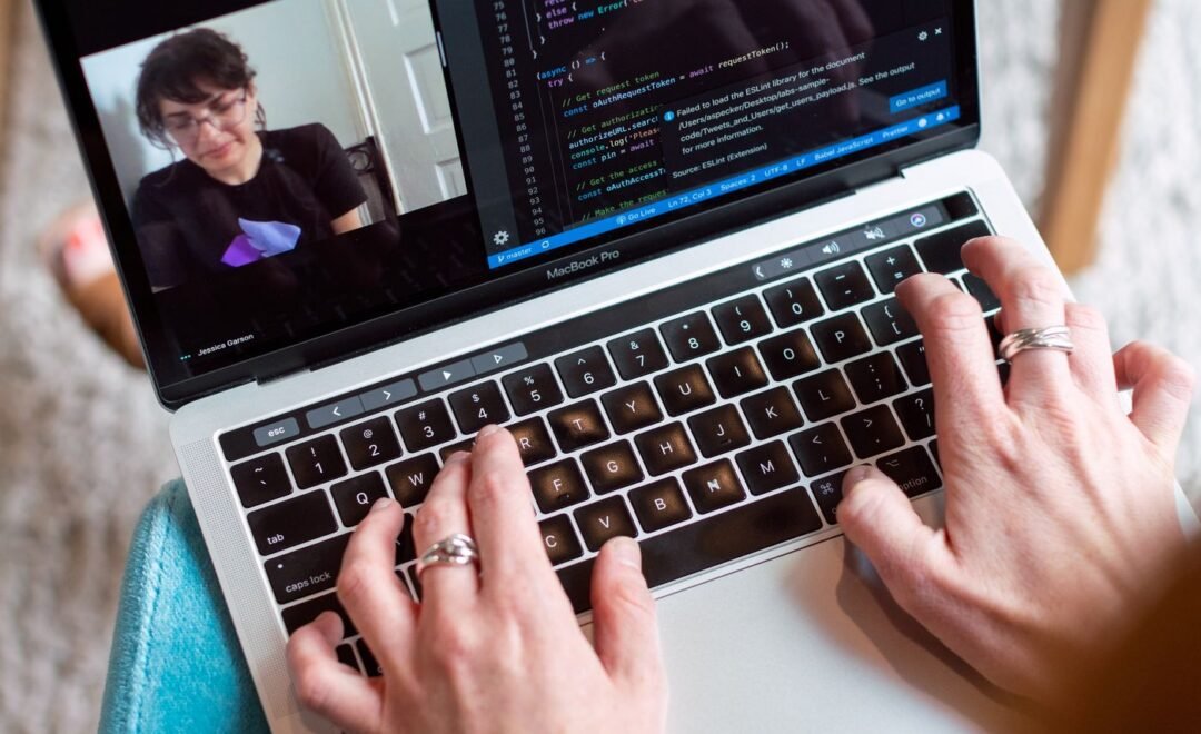 Reviewing code on a laptop in a dark room