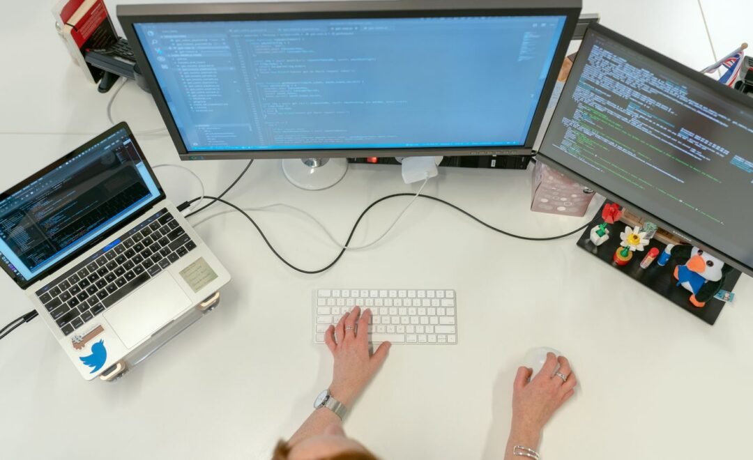 Laptops and phones on a desk during a build session