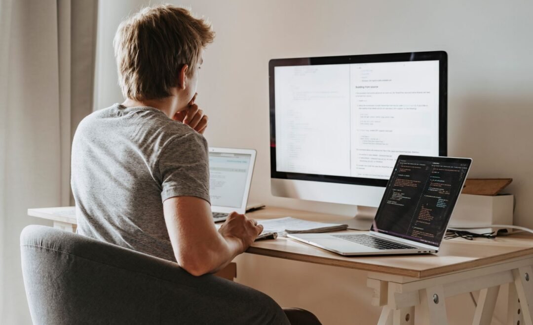 A content production desk with two screens