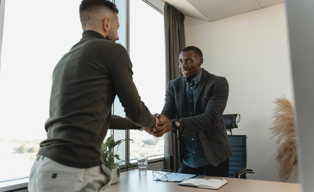 Two colleagues shaking hands in an office
