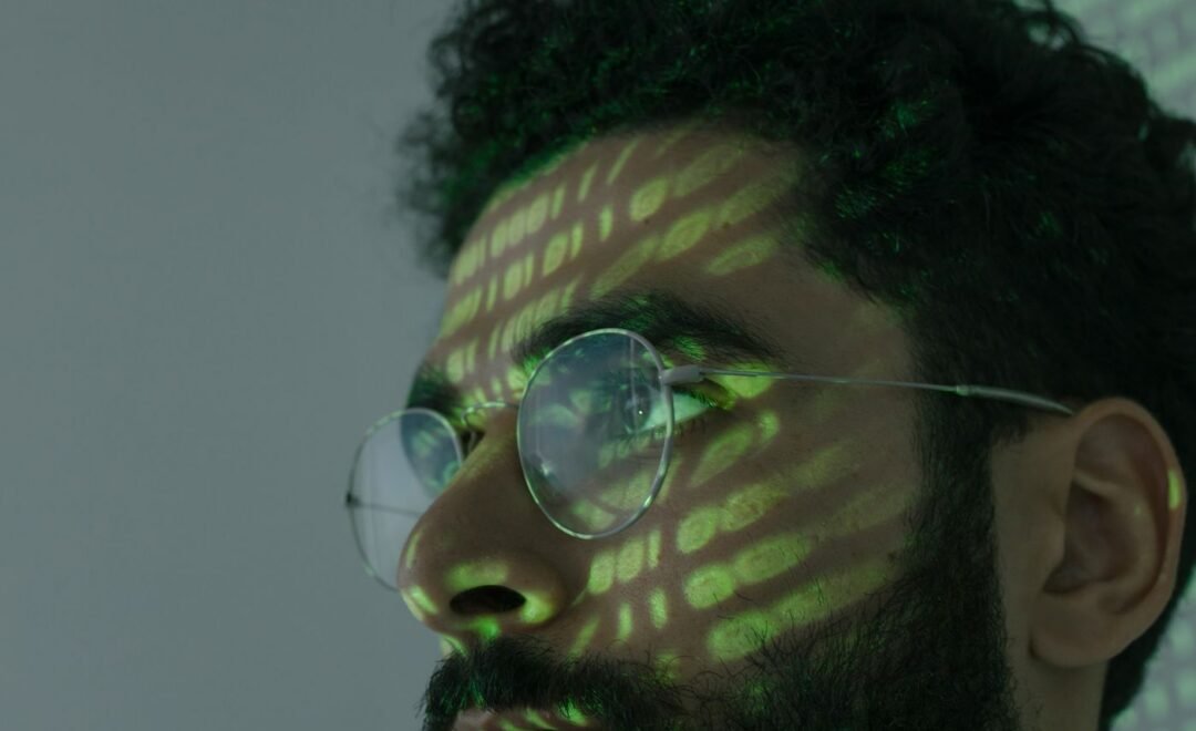 Light patterns across a face, representing digital exposure