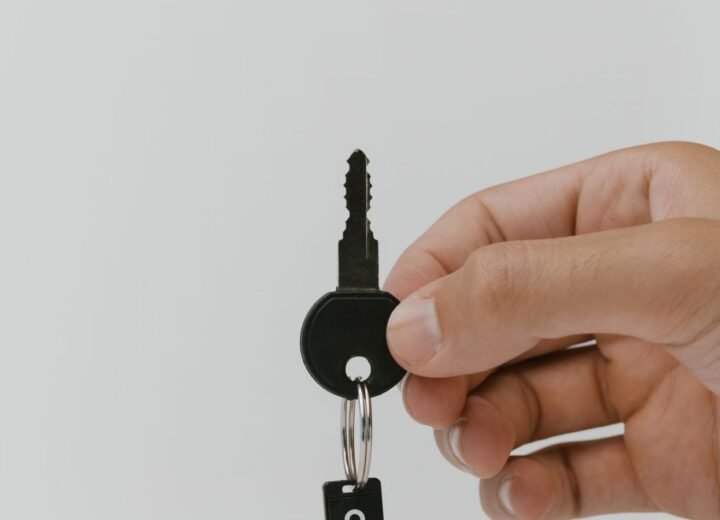 A hand holding a set of keys, representing access control