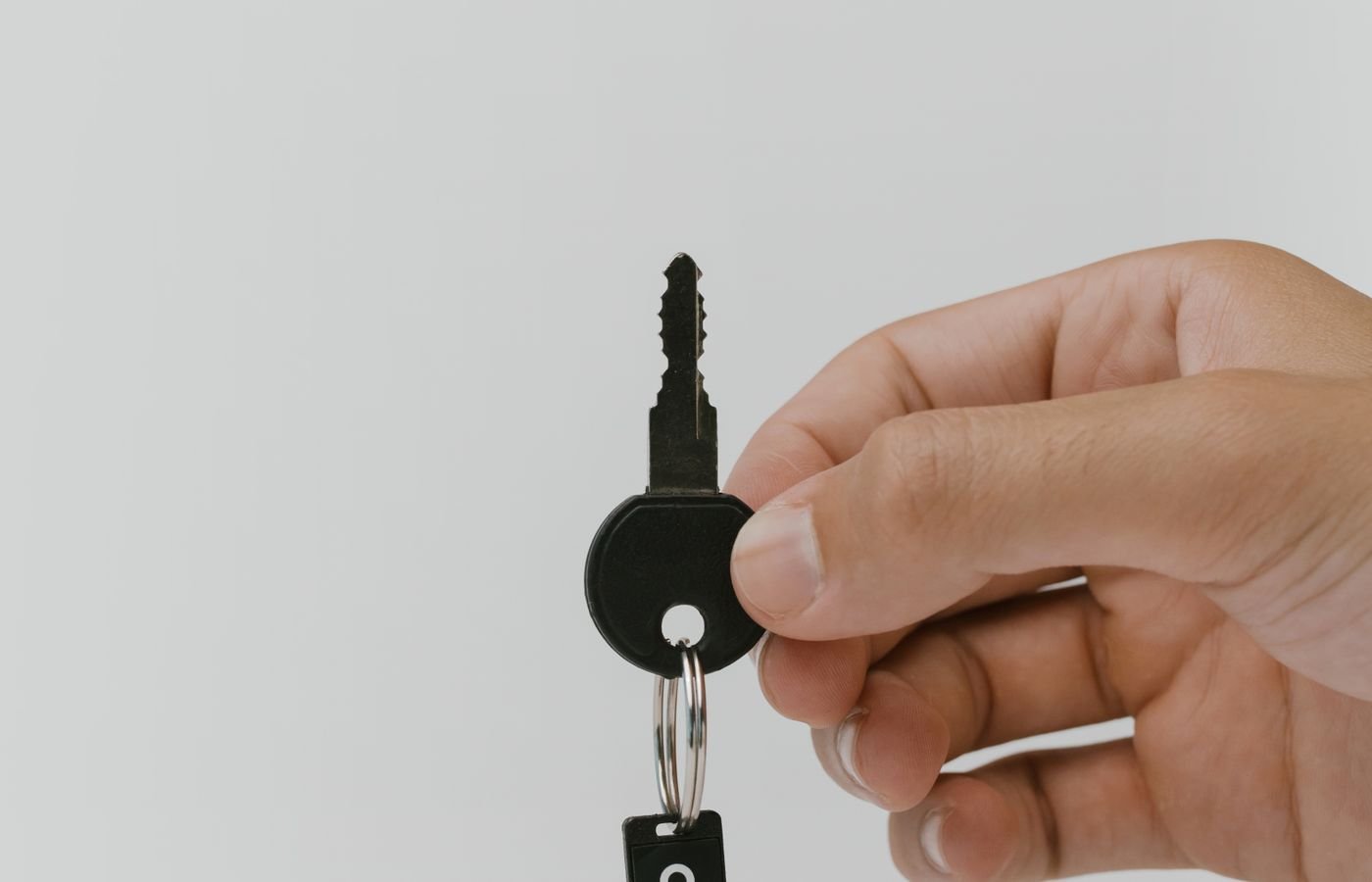 A hand holding a set of keys, representing access control