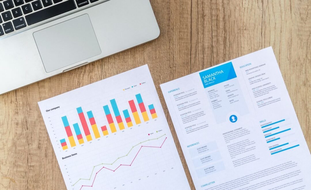 Printed performance reports spread across a desk