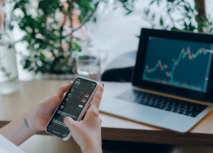 Reviewing app performance data on a phone next to a laptop