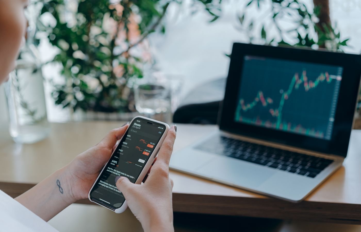 Reviewing app performance data on a phone next to a laptop