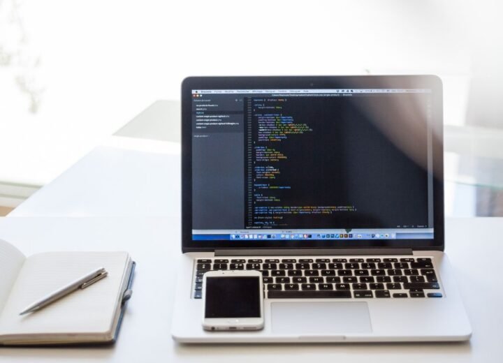 Laptop and notebook on a bright desk